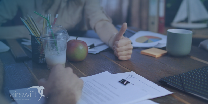 Recruiters talk over cvs on a table